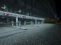 a parking lot with several signs lit up in the dark at night time's