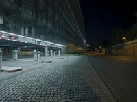 a parking lot with several signs lit up in the dark at night time's