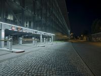 a parking lot with several signs lit up in the dark at night time's