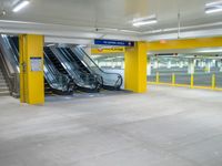 the empty car park with an escalator on the right and several escalators to either side