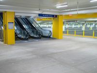 the empty car park with an escalator on the right and several escalators to either side