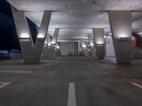 an empty parking garage with benches on both sides and stairs leading up to it to a city