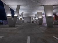 an empty parking garage with benches on both sides and stairs leading up to it to a city