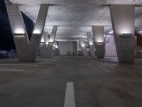 an empty parking garage with benches on both sides and stairs leading up to it to a city