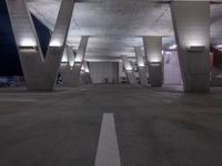 an empty parking garage with benches on both sides and stairs leading up to it to a city