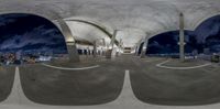 a fish eye view of a parking lot at night in a city with multiple ramps