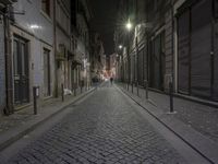 an empty street at night with a dark sky in the background, along the cobblestones, in downtown, in paris