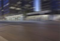a motorcycle on the side of the street as the view goes along behind it in a blurry motion