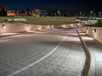 a view of a road and an overpass with traffic passing through it by buildings