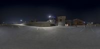 a photo taken in a fish eye lens with an empty parking lot at night time