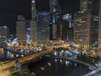 the city's skyline is lit up and the water is moving by itself in the dark