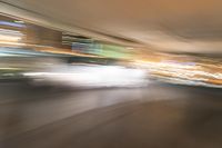 an abstract photograph of a skateboard on a street corner in motion with the camera going right to it