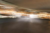 an abstract photograph of a skateboard on a street corner in motion with the camera going right to it