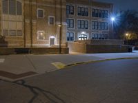 a fire hydrant sits on the side of a road at night with no one in it