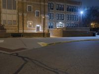 a fire hydrant sits on the side of a road at night with no one in it