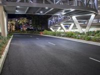 a view of a road and an overpass with traffic passing through it by buildings