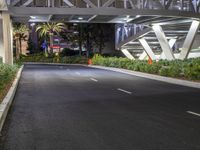 a view of a road and an overpass with traffic passing through it by buildings