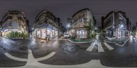 a panorama shot shows a street at night with multiple different lights and signs all on the same