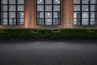 there is a empty parking lot outside of a building and a clock on the building