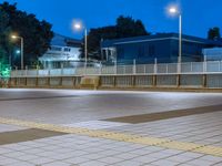 people standing on a subway platform with many buildings in the background at night light in tokyo