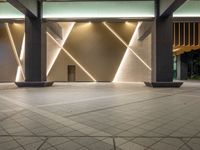 a hallway with columns on the wall that have led lights coming out of them and a door is behind the wall