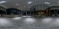 a fisheye photo shows an empty lobby with round windows and a wall covered in mirrors