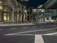 an image of outside of the night time building with the lights turned on and the streets empty