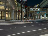 an image of outside of the night time building with the lights turned on and the streets empty