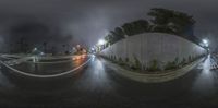 this is an image of the street corner in front of a wall and trees on either side