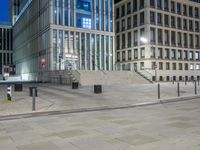 the street lights shine brightly over the empty walkways of the building's exterior