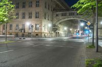 a long exposure photograph of the street and building at night and looking down at a street corner