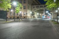 a long exposure photograph of the street and building at night and looking down at a street corner