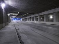 an empty parking garage with no people in it at night time time with only one stop sign