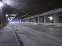 an empty parking garage with no people in it at night time time with only one stop sign