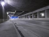 an empty parking garage with no people in it at night time time with only one stop sign