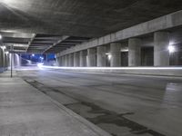 an empty parking garage with no people in it at night time time with only one stop sign