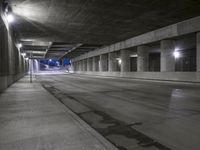 an empty parking garage with no people in it at night time time with only one stop sign