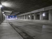 an empty parking garage with no people in it at night time time with only one stop sign