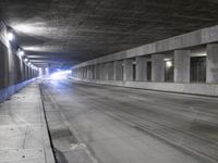 an empty parking garage with no people in it at night time time with only one stop sign