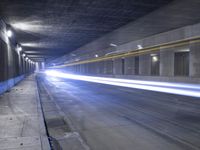 an empty parking garage with no people in it at night time time with only one stop sign