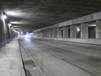 an empty parking garage with no people in it at night time time with only one stop sign