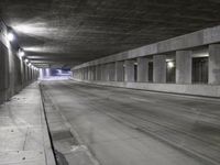 an empty parking garage with no people in it at night time time with only one stop sign