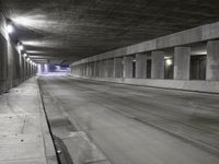 an empty parking garage with no people in it at night time time with only one stop sign