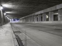 an empty parking garage with no people in it at night time time with only one stop sign