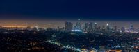 a view of downtown from the hollywood hills at night time with the los skyline lit up