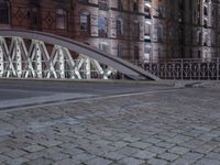 a pedestrian bridge over an empty street during night time, with no people in view