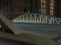 a pedestrian bridge over an empty street during night time, with no people in view