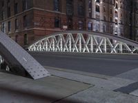 a pedestrian bridge over an empty street during night time, with no people in view