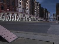 a pedestrian bridge over an empty street during night time, with no people in view