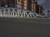 a pedestrian bridge over an empty street during night time, with no people in view